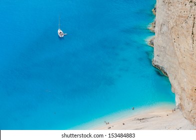 Tourists enjoy swimming in turquoise clear waters of hidden beach as a part of a private yacht cruise