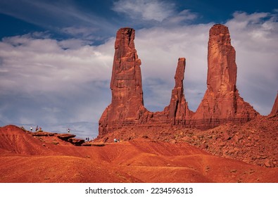 Tourists enjoying and admiring the beautiful Three Sisters Formation in Monument Valley, Arizona.