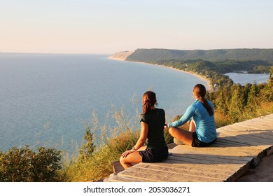 Tourists enjoying beautiful sunset scenery at the Empire Bluff Scenic Lookout, overlooking Lake Michigan, the Sleeping Bear Dunes, and the Manitou Island