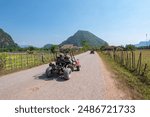 Tourists enjoying buggy ATV ride in Vang Vieng countryside, Laos