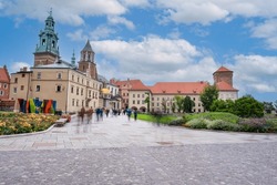 Tourists Enjoying The Landscaped Garden In The Interior Courtyard Of Wawel Castle In Krakow, Poland