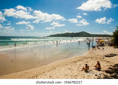 Tourists enjoying Main Beach of Byron Bay, a popular tourist destination in New South Wales, Australia.
