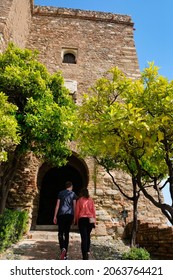 Tourists entering Torre del Cristo gate in La Alcazaba (Malaga - Spain)