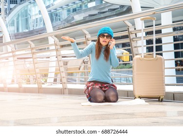 Tourists Girl Asian Searching Location In A Guide Map And Smart Phone With Airport In The Background