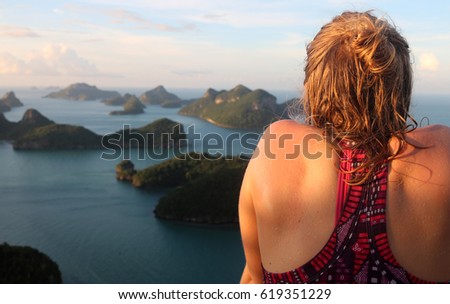  Tourists girl sweating by walking up the hill with view of ang thong archipelago island,Thailand.