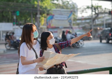 Tourists Girls Wearing Face Masks Ar Street. Women Travel During Coronavirus Quarantine. Summer Vacation. Friends Exploring New City Together. Travel 2020. Lifestyle, Friendship And Holidays.