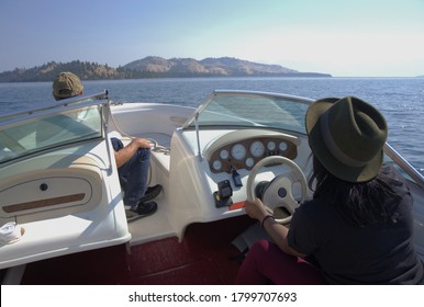 Tourists guide a boat across Flathead Lake toward Wild Horse Island, Montana.