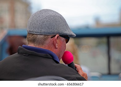 Tourists And A Host On A Hop On Hop Off Open Top Bus