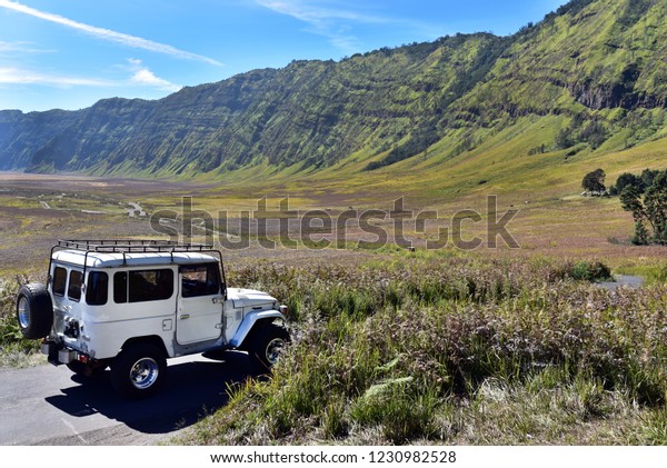 Tourists at the jeep tour around the Mount\
Bromo in sunny day, Java Island,\
Indonesia