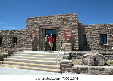 Tourists Leave The Building Of The Visitor Center And Rainbow Forest Museum Of The Petrified Forest.  National Park In Arizona. US