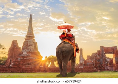 Tourists Lover On An Ride Elephant Tour Of The Ancient City Sunset ,ayutthaya, Thailand 