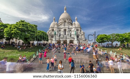 Tourists near the Basilica of the Sacred Heart of Paris (Sacra-Coeur) is a Roman Catholic church timelapse hyperlapse. Located at the summit of the butte Montmartre. Paris, France.