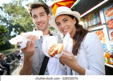 Tourists in New York city eating hot dogs