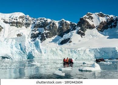 Tourists Observing A Glacier On The Antarctica, Paradise Bay, Antartica.