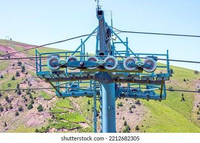 Сableway for tourists on green mountains and blue sky background in summer