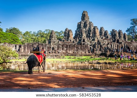 Tourists on an ride elephant tour of Bayon temple in Angkor Thom,landmark in Siem Reap, Cambodia.
