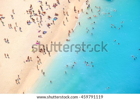 Tourists on the sand beach of Navagio Zakynthos Greece.