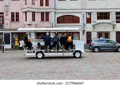 Tourists Pedalling In A Sightseeing Beer Mobile On Cobbled Street In Riga, Latvia - May 28, 2022