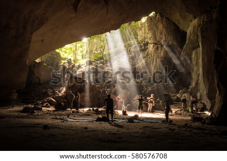Tourists in rainforest cave in Taman Negara, Malaysia