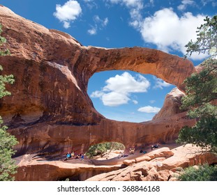 Tourists rest in the shade  Double O Arch,  Arches National Park, Utah