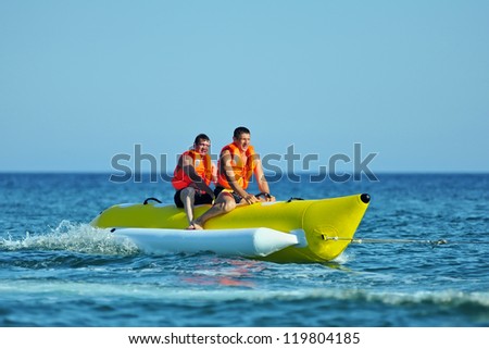 Tourists ride a Banana Boat