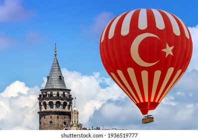 Tourists ride hot air ballon above Galata tower Istanbul city in Turkey