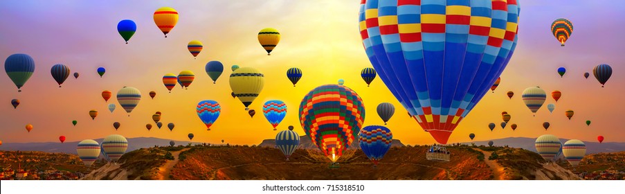Tourists ride hot air ballons during a mass ascension at the International Balloon Festival panorama