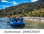 Tourists ride on the rafting facility, providing an interesting experience for travel enthusiasts. Punakha, Bhutan