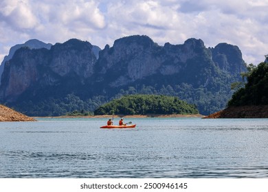 Tourists riding kayak on Cheo Lan lake at Surat Thani province of Thailand. Picturesque landscape of national Khao Sok park - Powered by Shutterstock