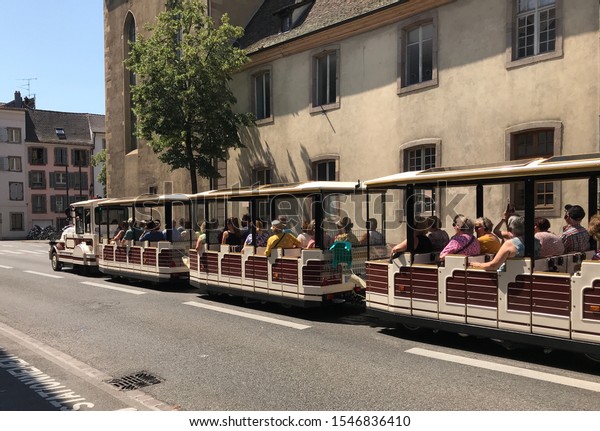 Tourists sightseeing classic\
train car at Colmar, France. Taken 20 June 2019 during summer\
holidays.