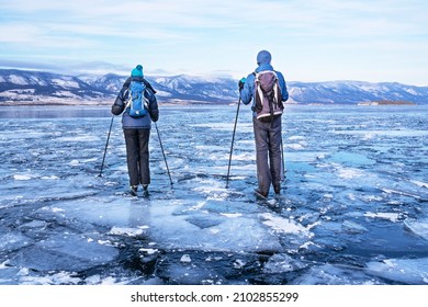 Tourists Skate On The Ice Of Lake Baikal. Nordic Skate Skates Designed Specifically For Skating On Lakes, Rivers, Canals And Bays. Active Rest.  Winter Vacation  And Travel Concept.