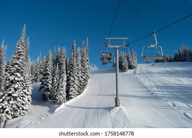 Tourists In Ski Lift Over Ski Resort, Sun Peaks Resort, Sun Peaks, British Columbia, Canada