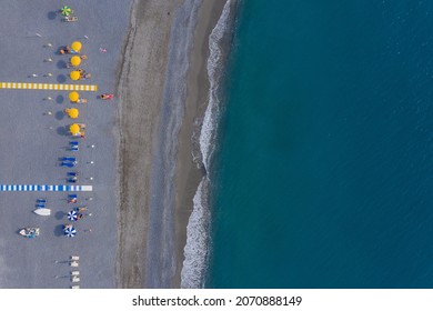 Tourists Sunbathing On Mediterranean Pebble Sea Beach, Aerial Top View