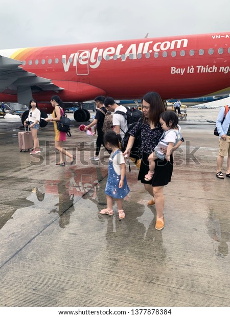 Tourists take photos next to\
the plane before boarding the plane - Hanoi, Vietnam on April 16,\
2019