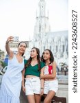 Tourists taking a selfie at the Ortiz Bridge with La Ermita church on background in the city of Cali in Colombia