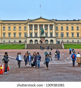 Tourists Visit The Royal House Of Norway. Sightseeing. Statue Of King Karl Johan In Front Of Royal Palace In Oslo. Official Residence Of Norwegian Monarch. Norway, Oslo – November 4, 2017