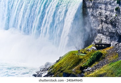 Tourists visiting under Niagara Falls.