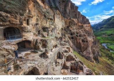 Tourists visiting Vardzia ancient cave city on a spring day in May. Vardzia is one of the main attraction in Georgia.