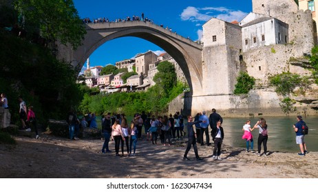 Tourists Are Waiting For A Bosnian Diver To Jump Into The River Neretva. Mostar, Bosnia And Herzegovina, April 2019.