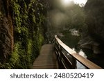 Tourists walk along the walkways of the Cerrada de Elías on the Borosa River route, in the Sierra de Cazorla, Segura y las Villas natural park. Andalusia. Jaen. Spain