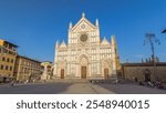 Tourists walking on Piazza di Santa Croce timelapse hyperlapse with Basilica di Santa Croce (Basilica of the Holy Cross) in Florence city before sunset. The church is burial place of famous Italians.