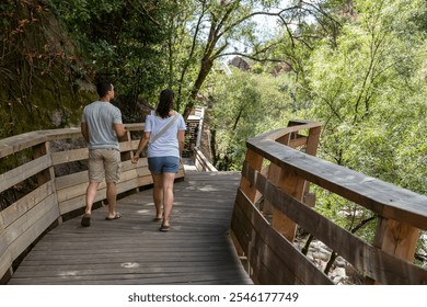 Tourists walking on a trail among the dense vegetation of Passadiços do Corgo in a natural and peaceful environment in Vila Real, Portugal - Powered by Shutterstock