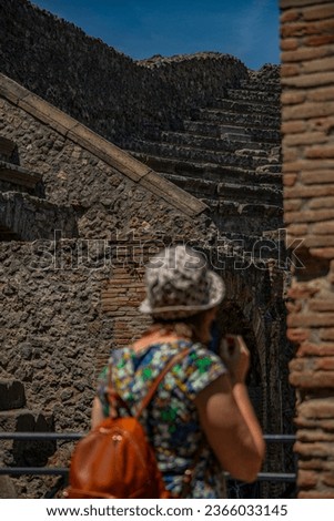 Tourists walking through the streets of ruined Pompeii