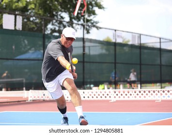 A Tournament Pickleball Players Hits A Shot