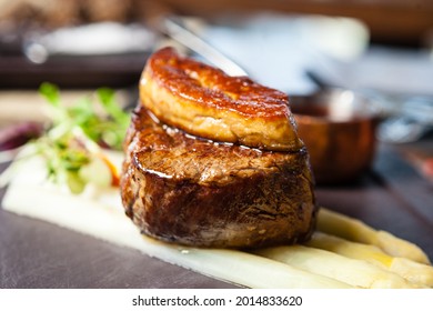 Tournedos Rossini. Foie Gras, Black Angus Beef Tenderloin, White Asparagus, Red Wine Sauce. Delicious Healthy Traditional Food Closeup Served For Lunch In Modern Gourmet Cuisine Restaurant.