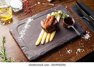 Tournedos Rossini. Foie Gras, Black Angus Beef Tenderloin, White Asparagus, Red Wine Sauce. Delicious Healthy Traditional Food Closeup Served For Lunch In Modern Gourmet Cuisine Restaurant