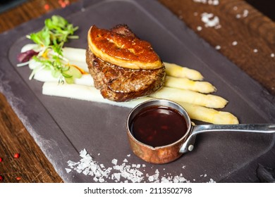 Tournedos Rossini. Foie Gras, Black Angus Beef Tenderloin, White Asparagus, Red Wine Sauce. Delicious Healthy Traditional Food Closeup Served For Lunch In Modern Gourmet Cuisine Restaurant