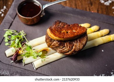 Tournedos Rossini. Foie Gras, Black Angus Beef Tenderloin, White Asparagus, Red Wine Sauce. Delicious Healthy Traditional Food Closeup Served For Lunch In Modern Gourmet Cuisine Restaurant