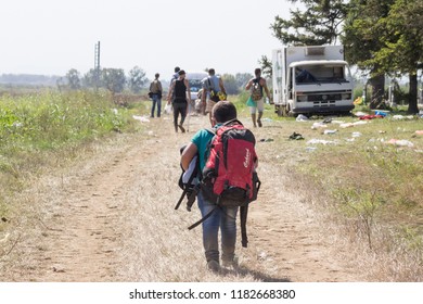 TOVARNIK, CROATIA - SEPTEMBER 19, 2015: Young Refugee Child Carrying Heavy Backpack On The Croatia Serbia Border, Between Cities Of Sid  & Tovarnik On The Balkans Route, During The Refugee Crisis

