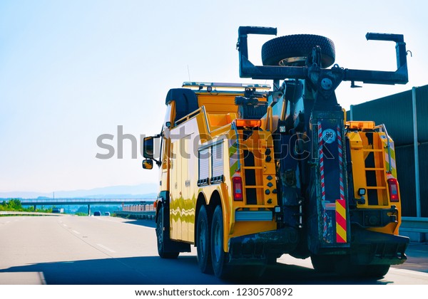 Tow truck for carrying long vehicles on the\
highway road in Slovenia.